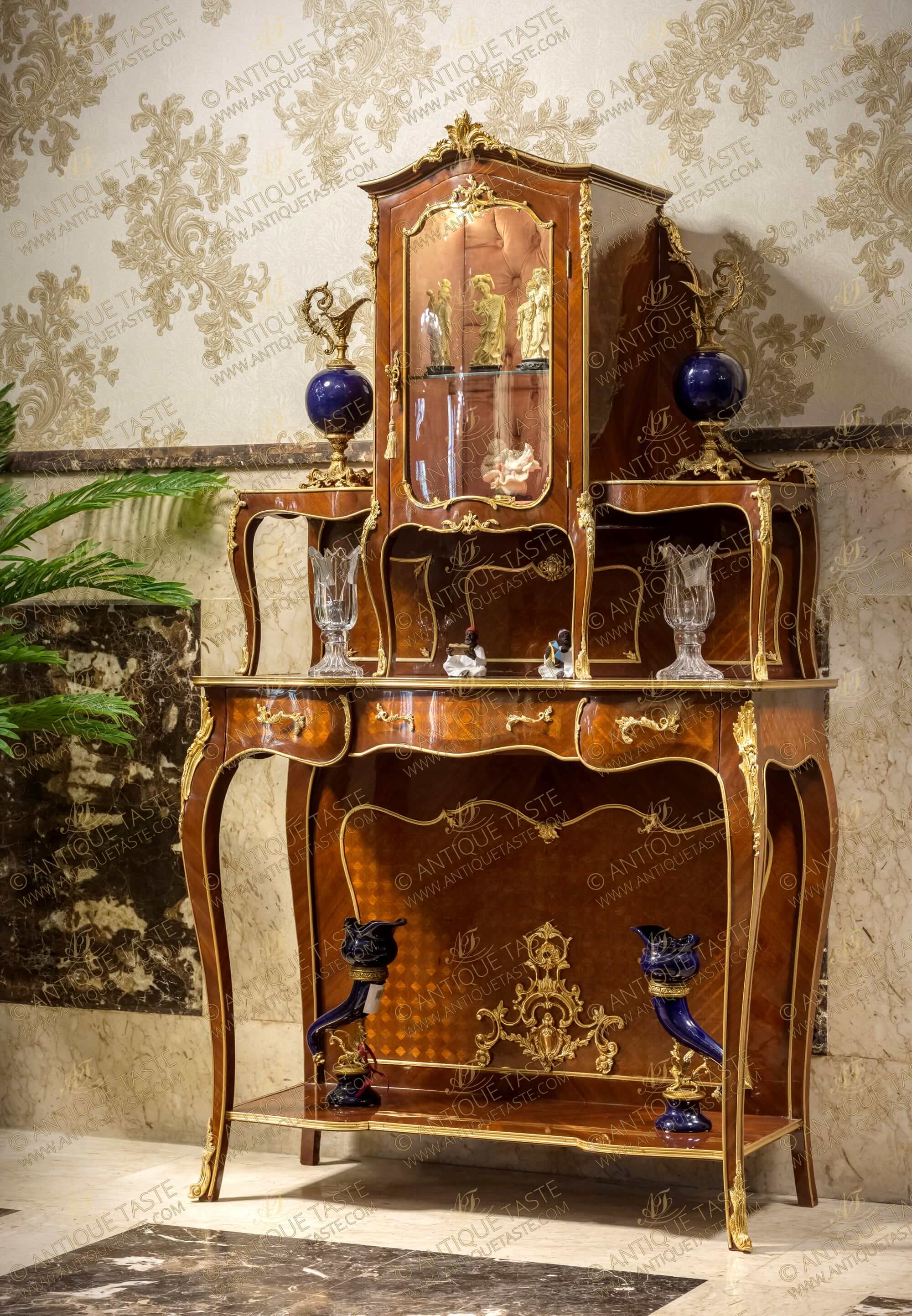 A stunning Louis XV style ormolu-mounted veneer inlaid and parquetry Two Tier Royal Console De Desserte and Vitrine Cabinet after the model by Francois Linke upholstered with tufted velvet and adorned with ormolu Rococo elements and foliate ormolu filet to the contour; with three central drawers and bombe glass door and lower shelf connecting the cabriole legs